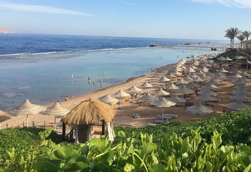 Nubian Island Hotel beach, Sharm El Sheikh — umbrellas, jetty and the Red Sea (photo: the hotel’s official website)