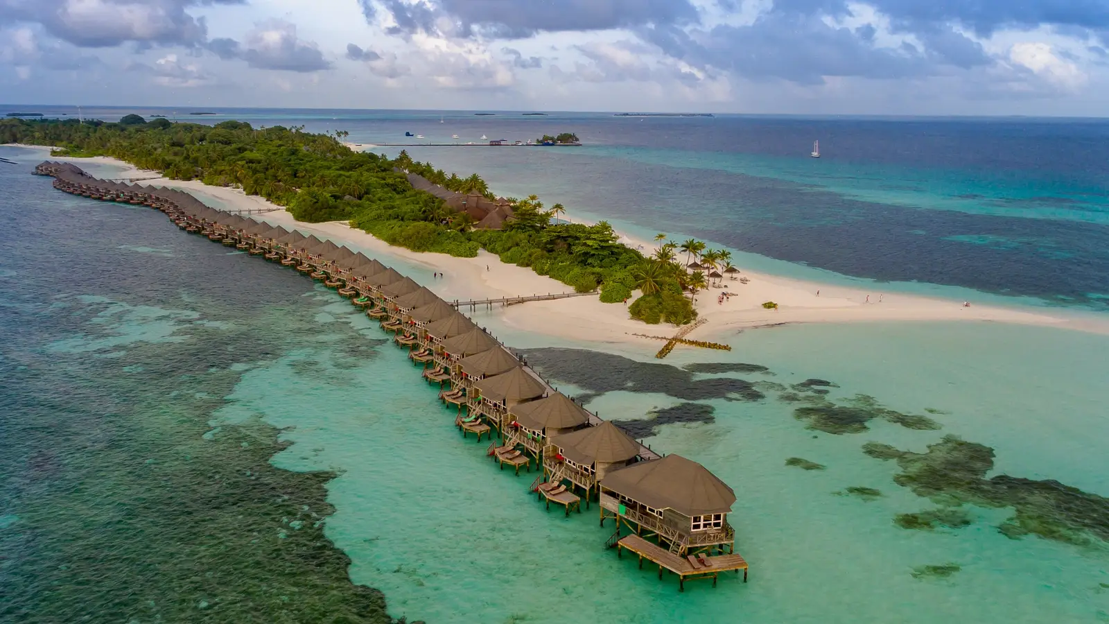 Aerial view of a row of over-water villas on a turquoise lagoon in the Maldives (photo: dronepicr / Wikimedia Commons, CC BY 2.0)